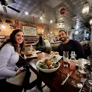 a man and a woman sitting at a restaurant table