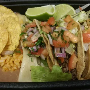Rice, beans, chicken tamal, beef (steak) taco, &amp; chicken taco