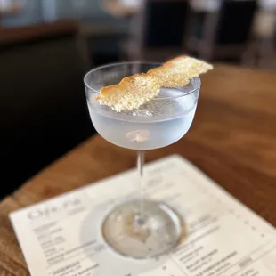 Stemware at Dolores: Four Pillars Olive Leaf Gin w/ olive brine, vinegar oil, salt &amp; vinegar focaccia chip | $16 (requested no olive brine)