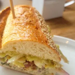 a sandwich on a plate with a toothpick