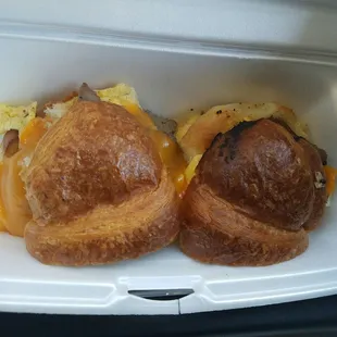 two croissants in a styrofoam container