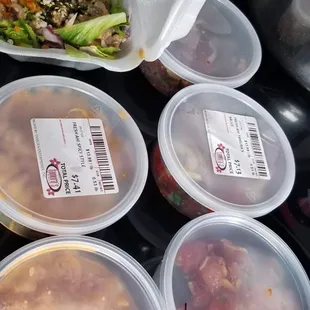 Poke taste testing.  Off Da Hook in Styrofoam container and da Hawaiian ahi in back