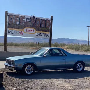 a car parked in front of a sign