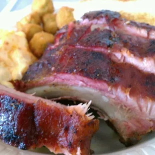 half rack of ribs hiding the bbq chicken underneath