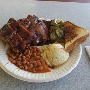 Ribs, sliced beef, potato salad, beans and condiments. Looks great!