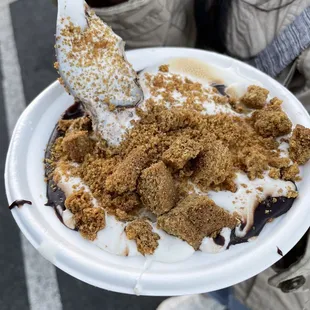  a woman holding a paper plate of food