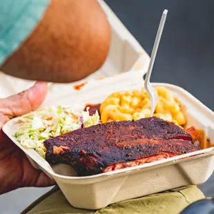  a man holding a tray of food