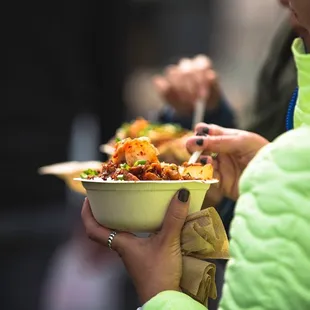  a woman holding a bowl of food