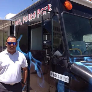 a man standing in front of a food truck