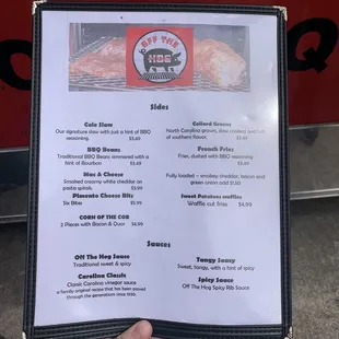 a hand holding a menu