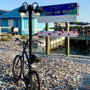 a bicycle parked next to a sign