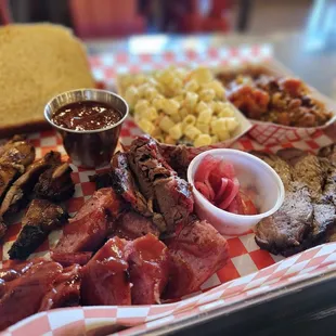 a tray of meat and sides