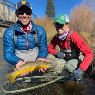 Beautiful shot of happy geasts fly fishing on the Truckee near Lake Tahoe for wild browns and rainbows.
