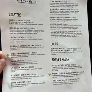 a hand holding a menu