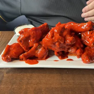 a plate of chicken wings with sauce