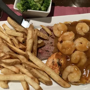 a plate of food with french fries and broccoli