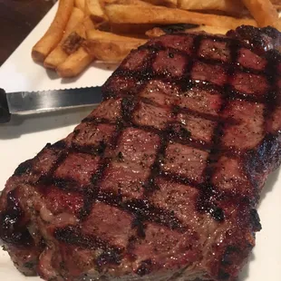 NY strip steak and fries. Cooked medium rare