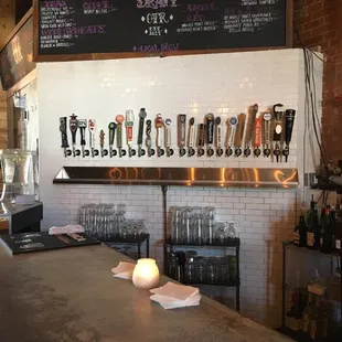 a row of beer taps on a bar