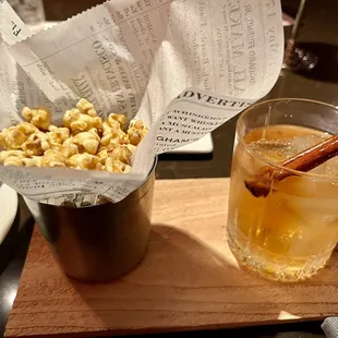 a glass of popcorn and a drink
