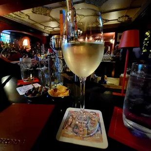 Glass of Sauvignon Blanc and bar view