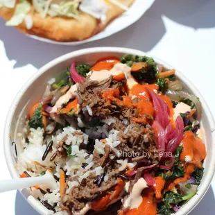 Braised bison wild rice bowl ($14.50)  topped with cream, romesco, and pickled red onions on a bed of wild rice