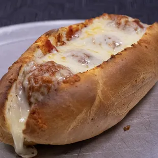 Crisp meatball hoagie covered in gooey cheese