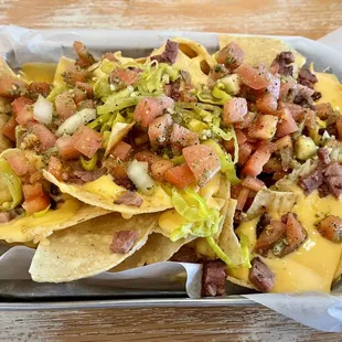 Smoked Brisket Nachos - you can taste allllll the goodness in this pic. Brisket cubes are plentiful and delish, cheesey, hearty!