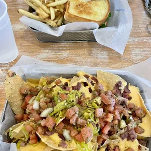 Smoked Brisket Nachos appetizer and (back) Pork Belly BLT - both delicious and both go down smooth with a nice draft brewski