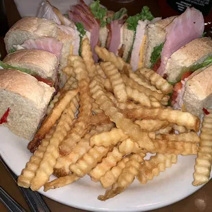a plate of french fries and a club sandwich