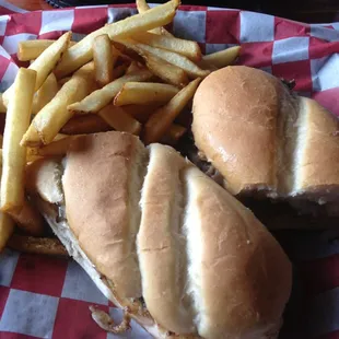 Philly steak with onions peppers and fries on the side