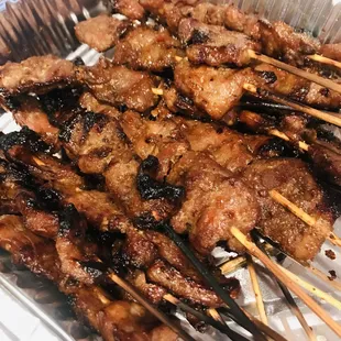 a tray of skewered meat