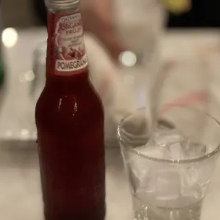 a bottle of ketchup and a glass of water