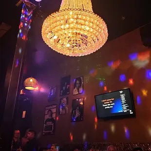 a chandelier in a dimly lit bar