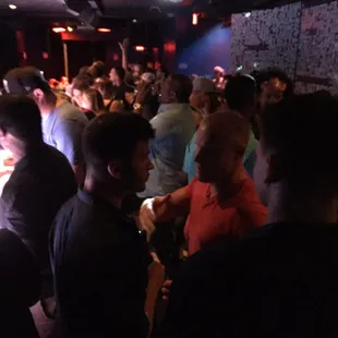 a large group of people in a dark room