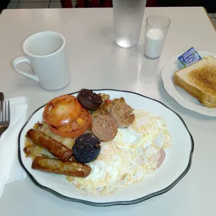 Irish Breakfast: Farm-fresh eggs, sausage, black &amp; White pudding, grilled tomato, Irish bacon, toast, juice and coffee. Delicious!