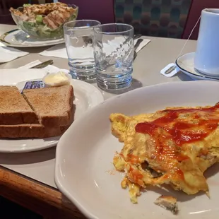 Grilled chicken omelette and wheat toast. Don&apos;t mind the ketchup, I just love ketchup so much