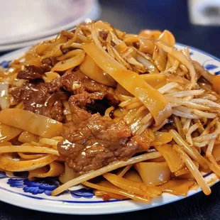a plate of beef and noodles
