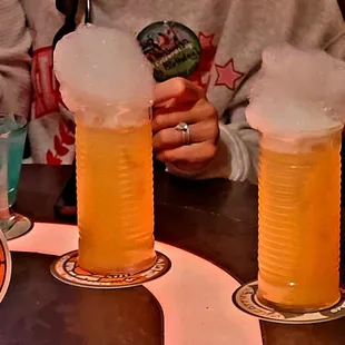 Fuzzy Tauntaun Cîroc Peach Vodka, Bols Peach Schnapps, and Simply Orange topped with Tangerine, Pure Cane Sugar, "Buzz Button Tingling" Foam