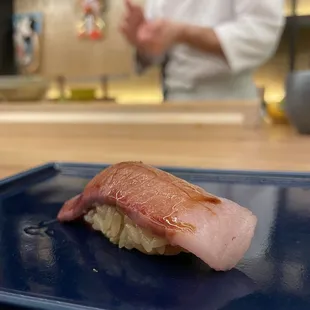 a sushi on a blue plate