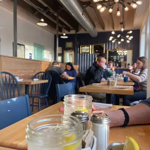 a man sitting at a table with a jar of lemonade