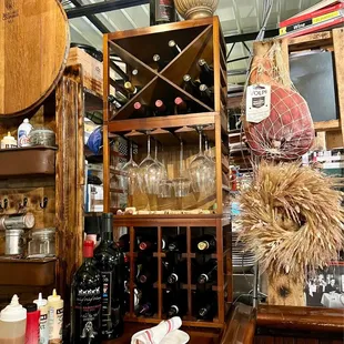 a wooden bar with wine glasses and bottles