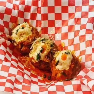 Clucker: Housemade Meatballs topped with Jack Cheese, Buffalo Sauce, Homemade "Ranch", Toasted Panko, and Chive