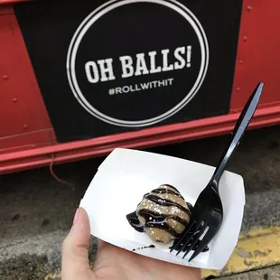 A sample of the dessert ball with chocolate sauce