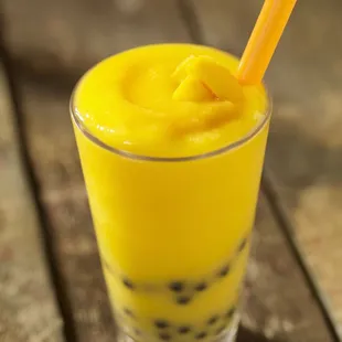 a glass of bubble tea on a wooden table