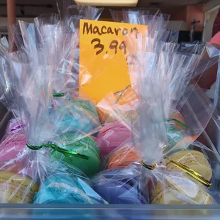 a plastic container filled with macarons