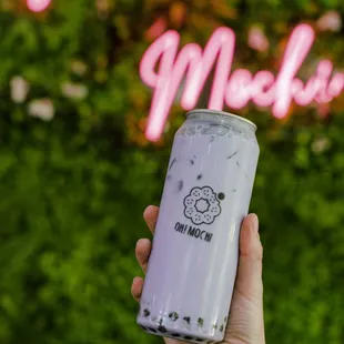 a hand holding a can of mocha