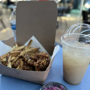 a container of fries and a drink