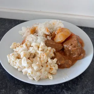 a plate of food with rice and meat