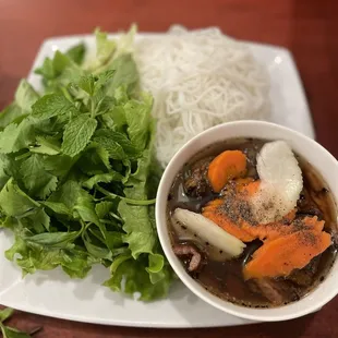 a bowl of soup and a plate of noodles