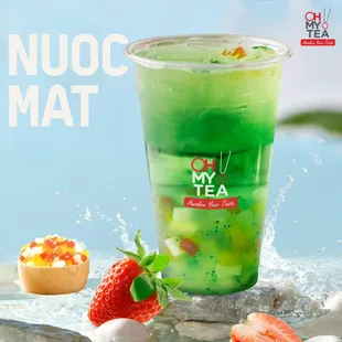 a cup of green tea with strawberries and fruit
